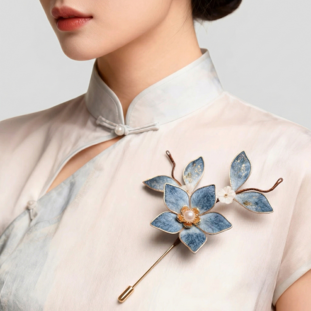 Model wearing the artisan blue floral lily pin on a traditional silk cheongsam, showcasing its elegant vintage style and scale.