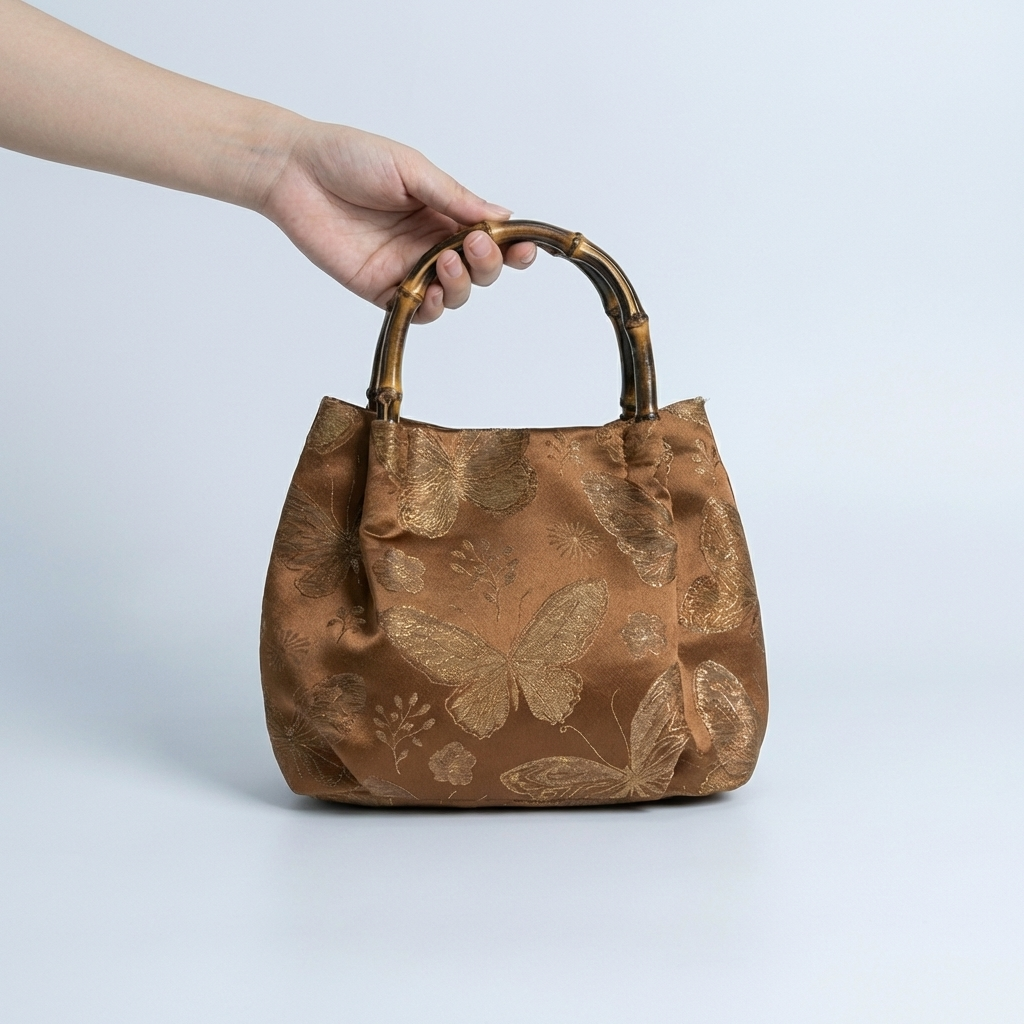 Model carrying the bronze brocade satchel, highlighting its role as a timeless keepsake and unique gift.