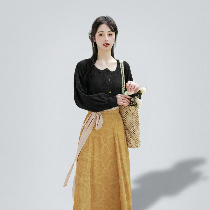Side view of the model wearing the black and yellow ensemble, demonstrating the skirt&