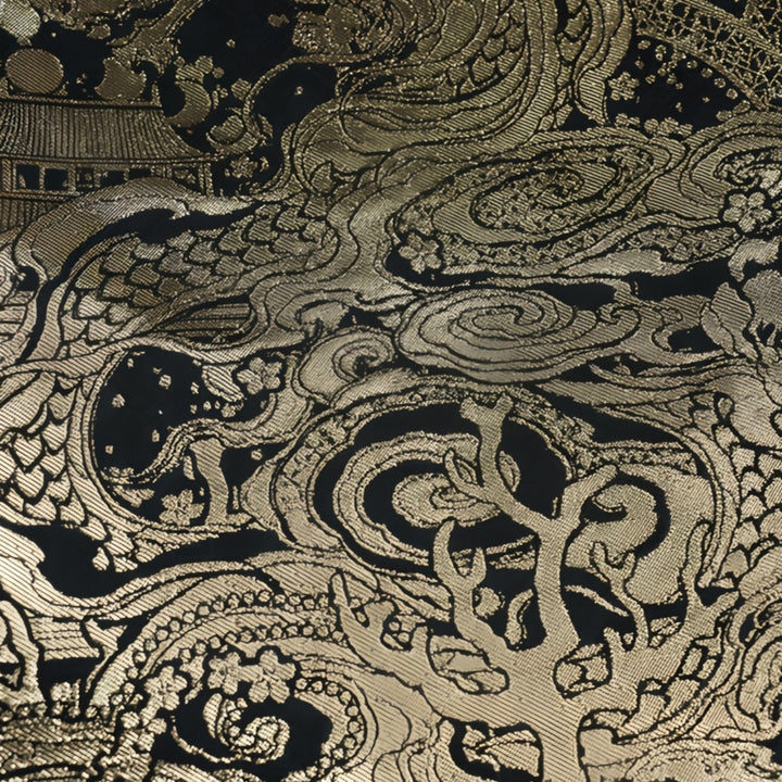 Extreme close-up of the intricate gold dragon embroidery on premium black fabric, highlighting the luxurious cultural craftsmanship.