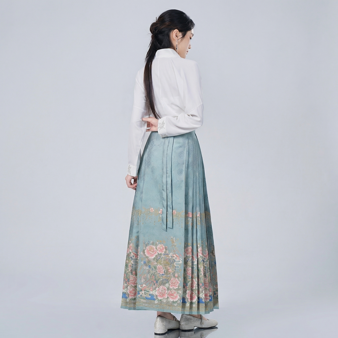 Side profile of the Chinoiserie wrap top and pleated skirt ensemble, demonstrating the graceful drape and flattering vintage-inspired silhouette.