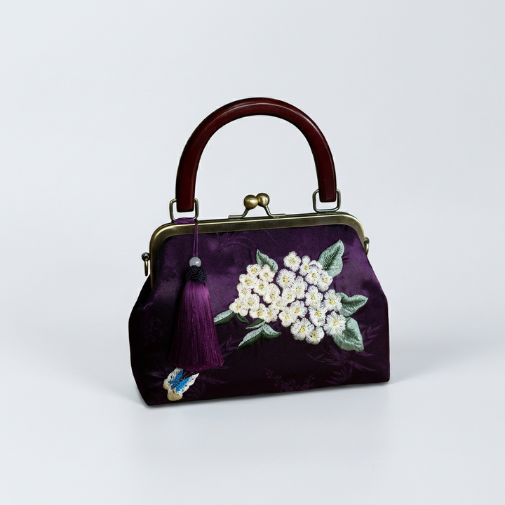 Deep purple heavy silk purse with exquisite white flower embroidery and a vintage-style wooden handle.