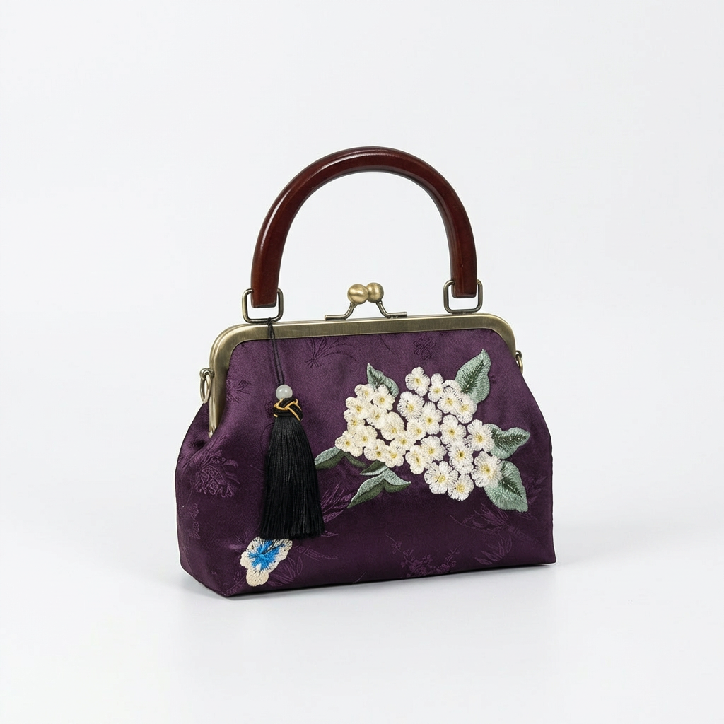 Angled view of the deep purple silk handbag showcasing the three-dimensional floral embroidery and kiss-lock frame.