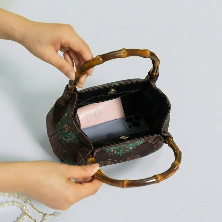 Open view of the deep red brocade satchel showing its clean interior and ample storage space.