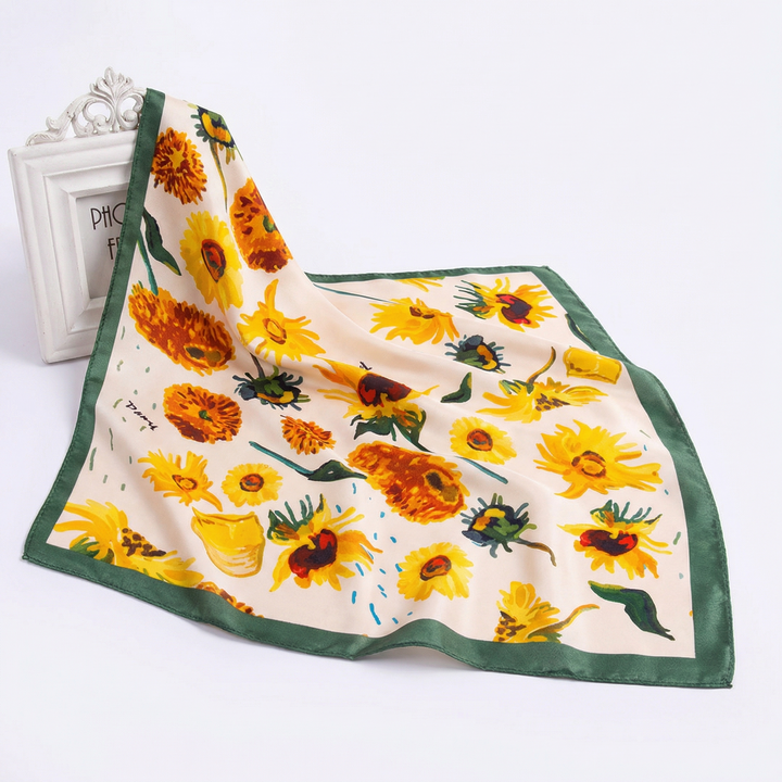Elegantly draped pure silk neckerchief displaying a radiant sunlit garden floral pattern with a rich green edge.