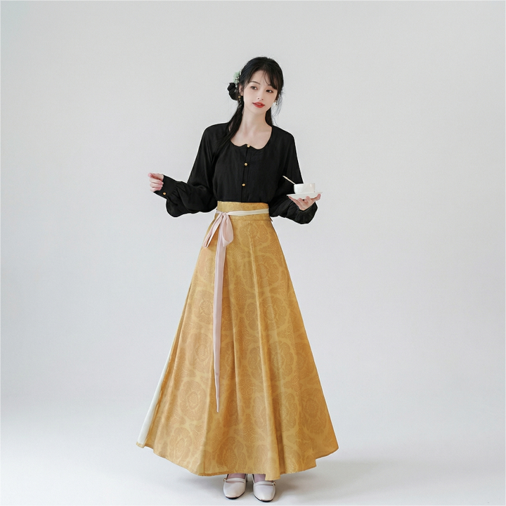 AuraOrient two-piece set featuring a tailored black blouse with subtle puff sleeves paired with a vibrant mustard yellow paneled maxi skirt.