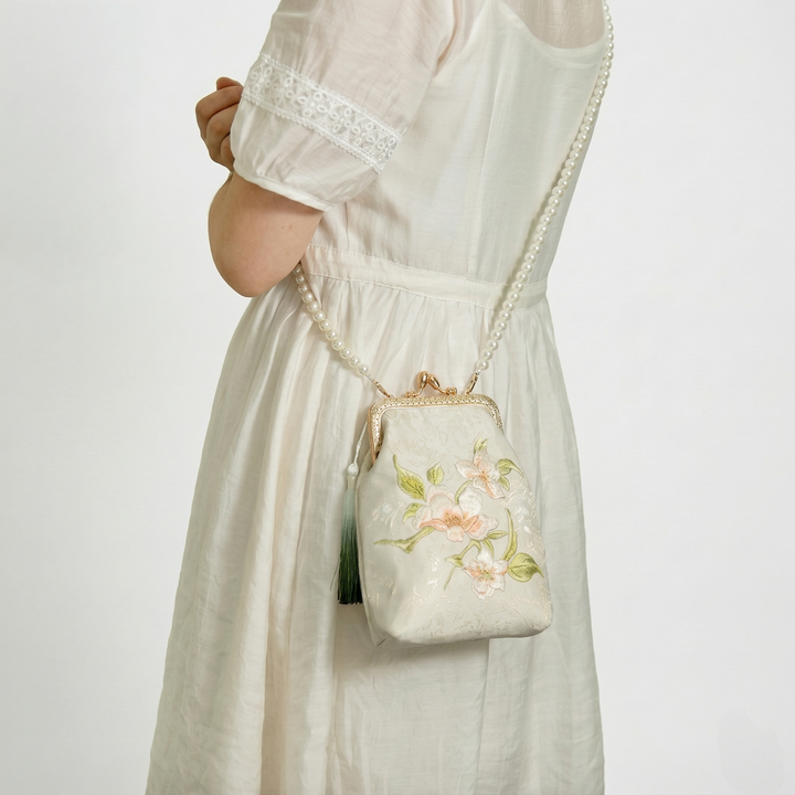 Side-carry look of the floral embroidered mini bag, showing its compact and lightweight design for everyday elegance.