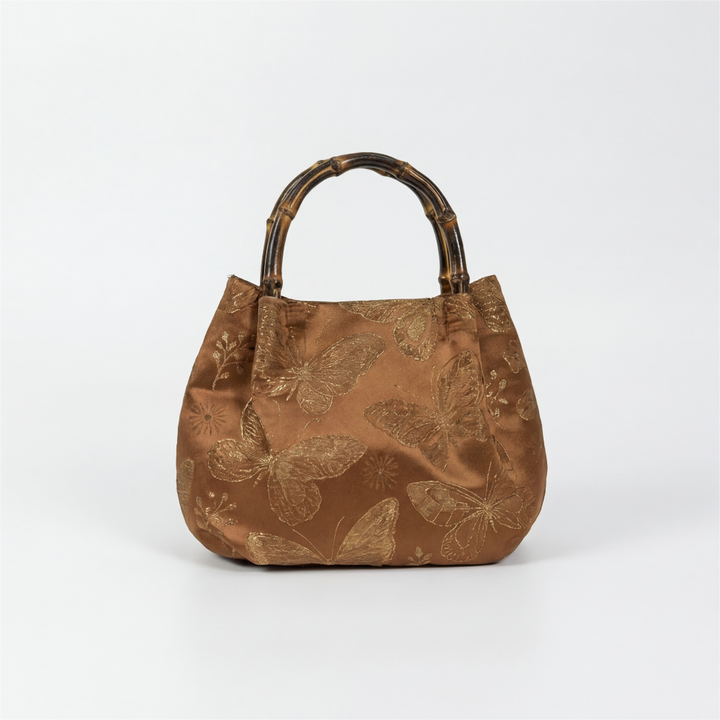 Front view of the handcrafted bronze Oriental satchel with premium silk-like brocade fabric.