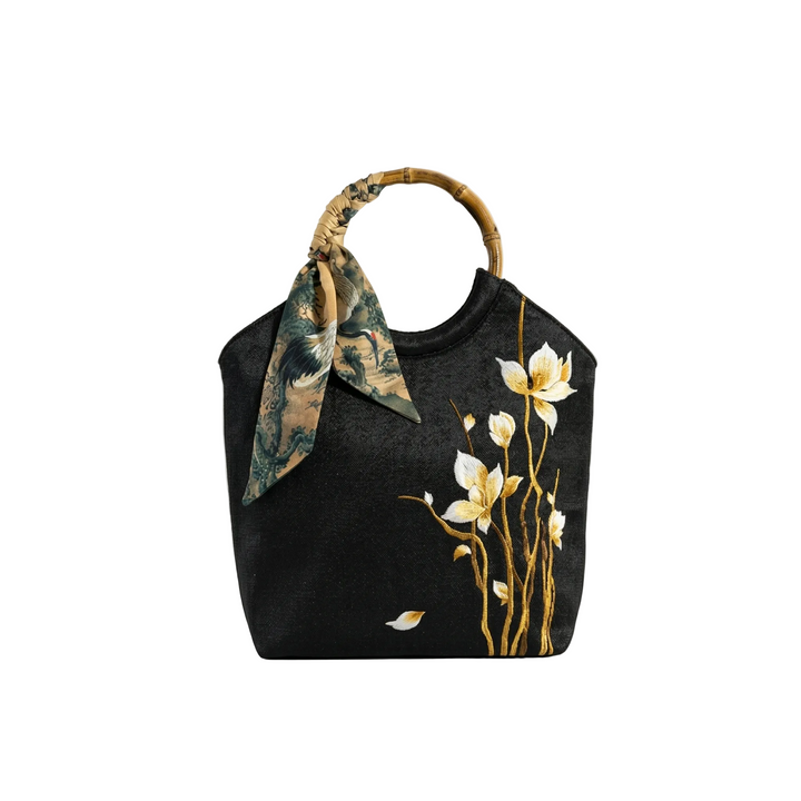 AuraOrient large black tote bag featuring golden floral embroidery, a bamboo ring handle wrapped with a decorative silk scarf.