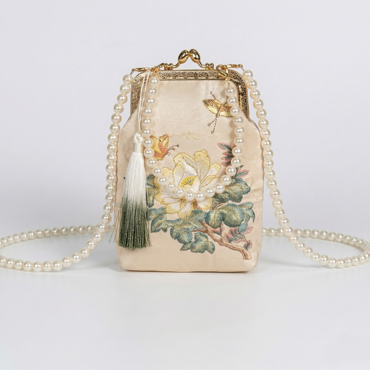Front view of the mini Chinoiserie chic purse featuring cherry blossom embroidery and a detachable gold crossbody chain.