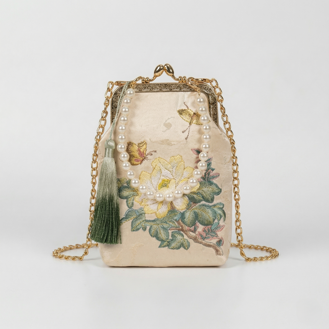 Mini floral embroidered handbag featuring a graceful faux pearl top handle for hand-carried elegance.