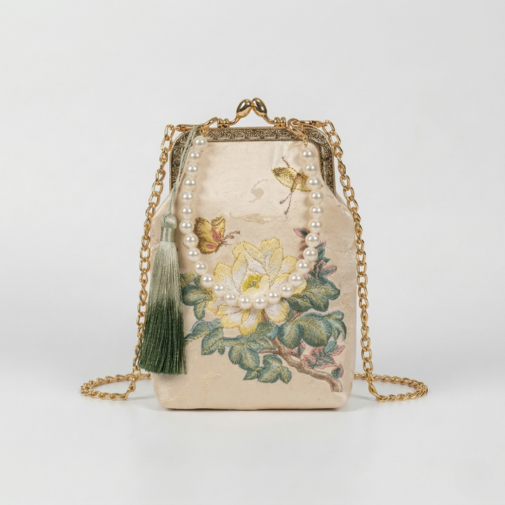 Mini floral embroidered handbag featuring a graceful faux pearl top handle for hand-carried elegance.