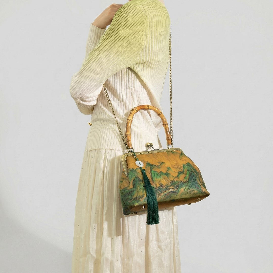 Model wearing the Oriental landscape painting bag as a crossbody bag, complementing a soft, neutral-colored aesthetic outfit.