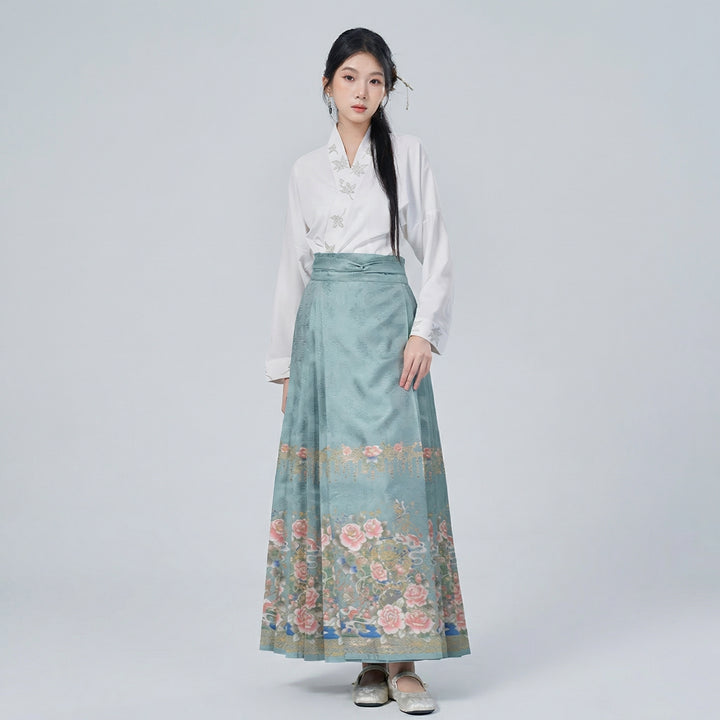 AuraOrient pastel floral Chinoiserie set featuring a delicate white cross-collar wrap top and a flowing pleated maxi skirt with vintage botanical motifs.