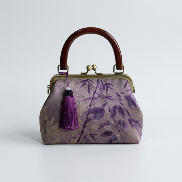 Purple premium artisan silk handbag featuring traditional Oriental floral and bird prints with a matching purple tassel.
