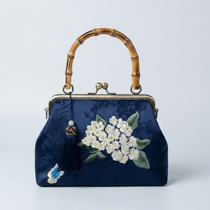 Vibrant royal blue silk purse with floral needlework and a natural bamboo handle in Oriental style.
