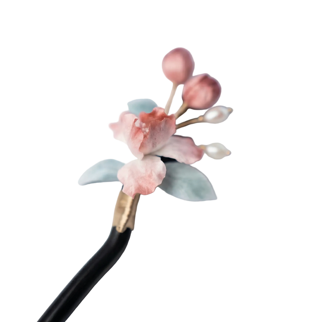 Close-up of the life-like pink iris blossoms handcrafted from premium silk velvet, showcasing the exquisite heritage artisan technique.