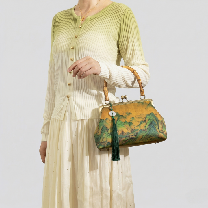 Fashion model holding the Chinoiserie bamboo handle purse, highlighting its role as a sophisticated statement piece for elegant styling.