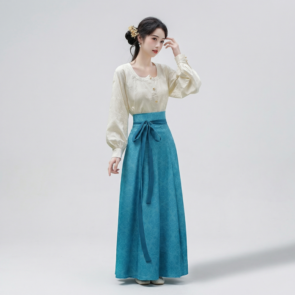 Full-length view of the teal blue flowing paneled skirt featuring a subtle vintage-inspired floral pattern and sweeping drape.