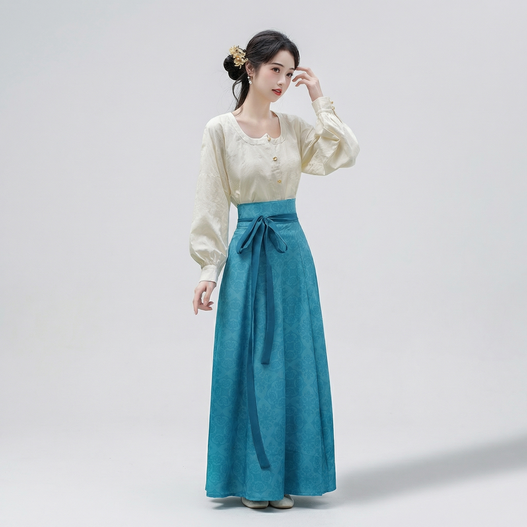 Full-length view of the teal blue flowing paneled skirt featuring a subtle vintage-inspired floral pattern and sweeping drape.