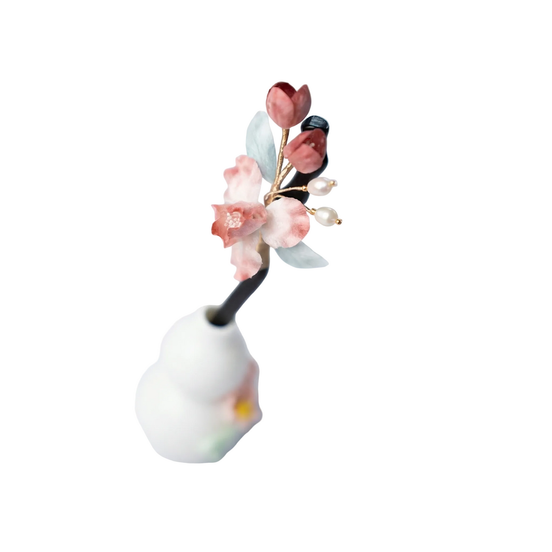 Side view of the vintage-style pink iris wooden hairpin, highlighting the elegant curve and the artistic floral arrangement.