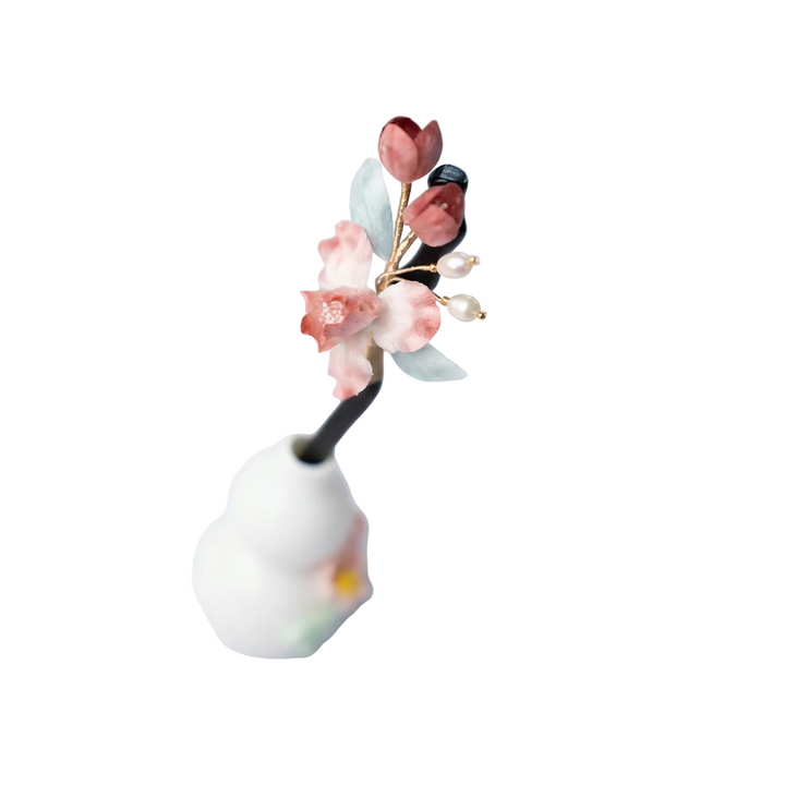 Side view of the vintage-style pink iris wooden hairpin, highlighting the elegant curve and the artistic floral arrangement.